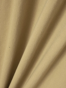 Macro view of khaki twill cotton shirt fabric showing dense diagonal weaving texture