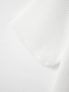 Vue macro du tissu en soie glacée à mailles blanches avec texture gaufrée sur un polo