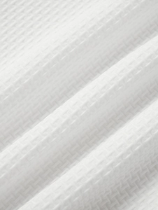 Vue macro du tissu gaufré blanc avec structure en nid d'abeille respirante de qualité