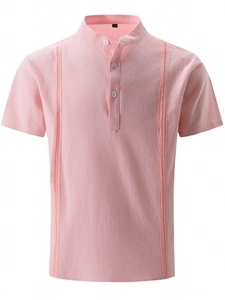 Detail of light pink Guayabera shirt showing vertical hollow embroidery and linen texture