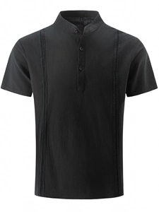 Close-up of black cotton linen shirt featuring intricate vertical hollow embroidery detail