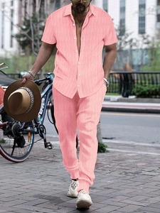 Close-up of men's summer coral pink short sleeve shirt and pants with vertical rib texture