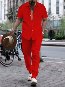 Detail of red ribbed knit shirt and pants set with white buttons for men