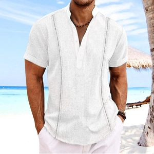 Men's white short sleeve linen shirt with vertical textures on a tropical beach background