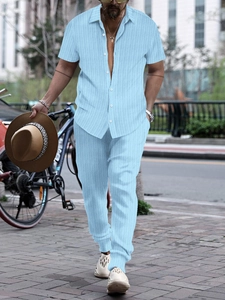 Detail of light blue short sleeve ribbed shirt and trousers set on a street background