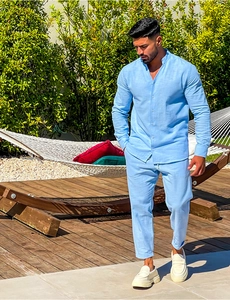 Detail of light blue linen shirt with mandarin collar and matching casual trousers
