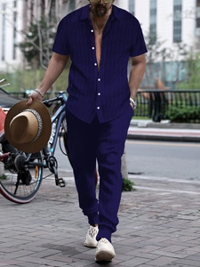 Detail of dark blue short sleeve button shirt and pants set with fine knit texture