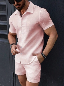 Men's pink waffle knit short sleeve shirt and shorts set shown in a stylish side view