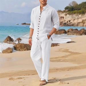 Men's white linen long sleeve shirt and drawstring pants beach set on a sunny coast