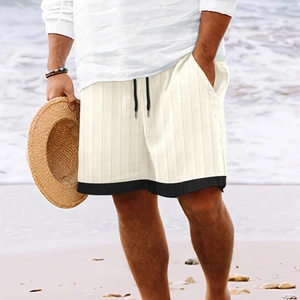 Summer men waffle knit shorts with striped patchwork and drawstring on a beach