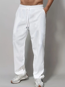 Men's white straight-leg cotton casual pants with elastic drawstring waist and textured fabric
