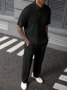 Detail shot of the vertical diamond texture on a black knitted men's polo set
