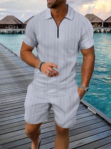 Close-up of light grey knit polo shirt and shorts set with quarter-zip detail