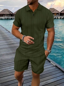 Detail of olive green men's knit polo set with vertical texture on seaside boardwalk