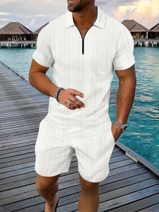 Detailed texture of white polo shirt with geometric knit pattern and zipper collar