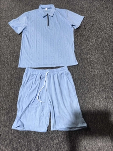 Detail of light blue men's polo set featuring a zipper neck and waffle texture fabric