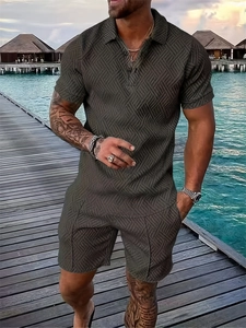 Detailed view of dark green mens textured polo and shorts set with wave pattern