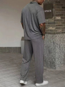 Close-up of grey men's polo set showcasing premium textured cable knit fabric detail