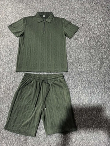 Detail of olive green men's knit polo set showing textured fabric and zipper collar