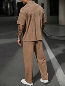 Close-up of men's coffee cable-knit polo and trousers set with textured fabric