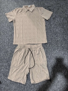 Detail of khaki men's polo set showing waffle knit texture, M size tag and black drawstring