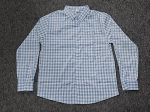 Detailed macro view of the collar and size label M on a blue plaid casual shirt