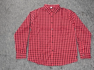 Flat lay detail of red and black gingham men's long sleeve shirt with chest pocket