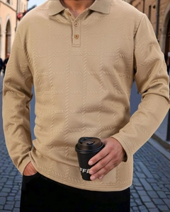 Close-up of khaki long sleeve polo shirt with textured geometric jacquard fabric pattern