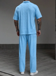 Rear view of men's knit polo set featuring blue textured jacquard fabric and casual fit