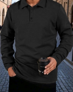 Close-up of black long-sleeve polo shirt featuring premium waffle texture and buttoned collar