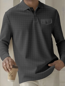 Detail of grey checkered polo shirt with buttoned flap pocket and waffle texture