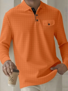 Detail of orange waffle knit polo shirt showing chest pocket and contrast collar buttoning