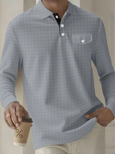 Detailed macro view of the quilted plaid texture and chest pocket on a grey men's Polo shirt
