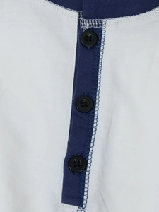 Close-up of white Henley shirt featuring navy blue trim and three-button placket detail