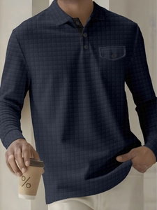 Detail of navy long sleeve polo shirt with diamond texture and chest pocket