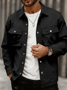 Detail of black slim fit utility jacket with silver buttons and large chest pockets