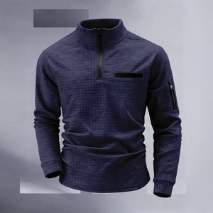 Detail of navy waffle textured polo shirt showing standing collar and zip sleeve pocket