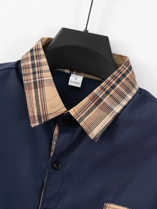 Detailed close-up of navy blue shirt collar with classic plaid pattern and size M label