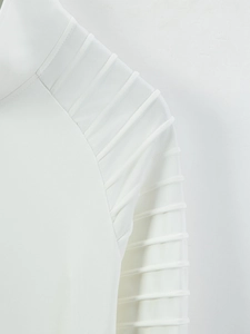 Detail of white jacket sleeve featuring unique 3D pleated design and textured fabric