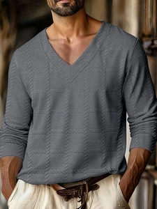 Detail of grey men's V-neck polo shirt showing textured knit fabric and premium weave