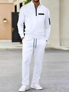 Men's white waffle knit two-piece set with a half-zip polo sweatshirt and matching pants