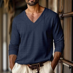 Close-up detail of navy blue V-neck tee showing textured waffle knit fabric for men