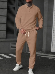 Detail of waffle textured long sleeve polo shirt and matching drawstring joggers set