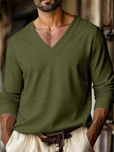 Close-up of olive green long-sleeved polo shirt showing waffle texture and V-neckline