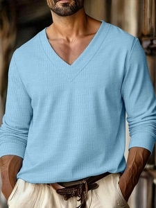 Detail shot of men's sky blue V-neck polo shirt showing unique textured square weave fabric