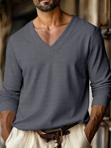 Detail shot of the textured grid jacquard fabric on the grey V-neck long sleeve shirt