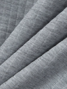 Close-up of the grey melange knit fabric texture on the men's polo set with soft folds