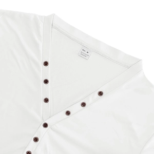 Detailed view of white Henley shirt collar featuring vintage brown buttons and knit texture