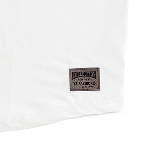 Detail of white cotton fabric hem with a rectangular woven fashion label and stitching