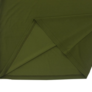 Gros plan du tissu en tricot vert olive avec couture double aiguille précise sur l'ourlet